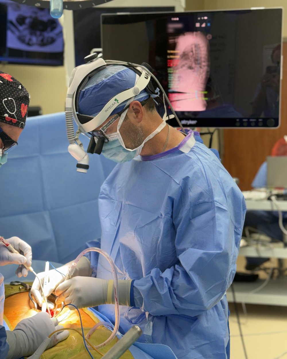 Dr. Hobbs performing image-guided spine surgery with live navigation on screen