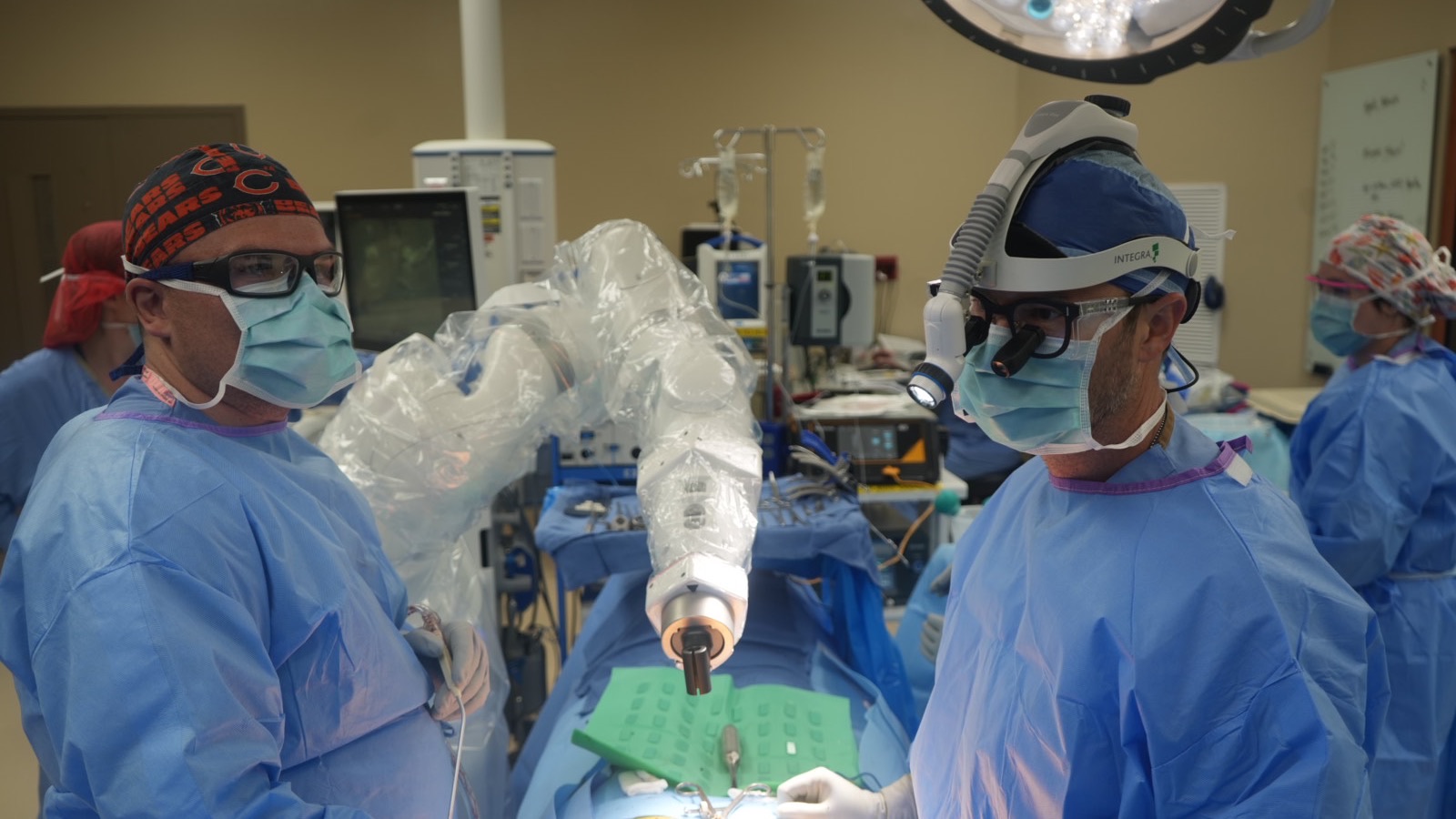 Dr. Hobbs and a colleague on either side of the robotic arm during the first case